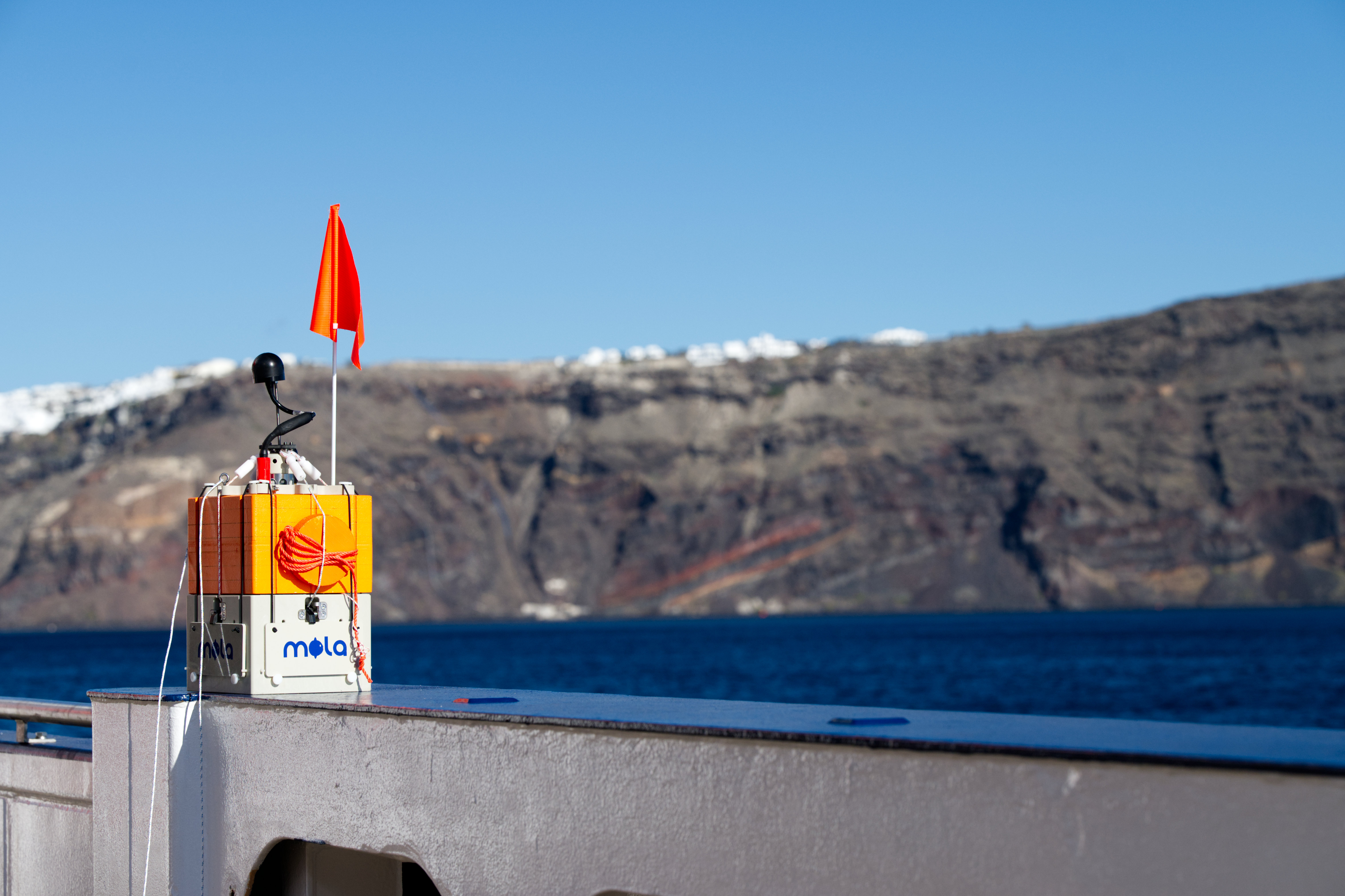 MOLA lander with caldera in background, ready for deployment offshore Santorini